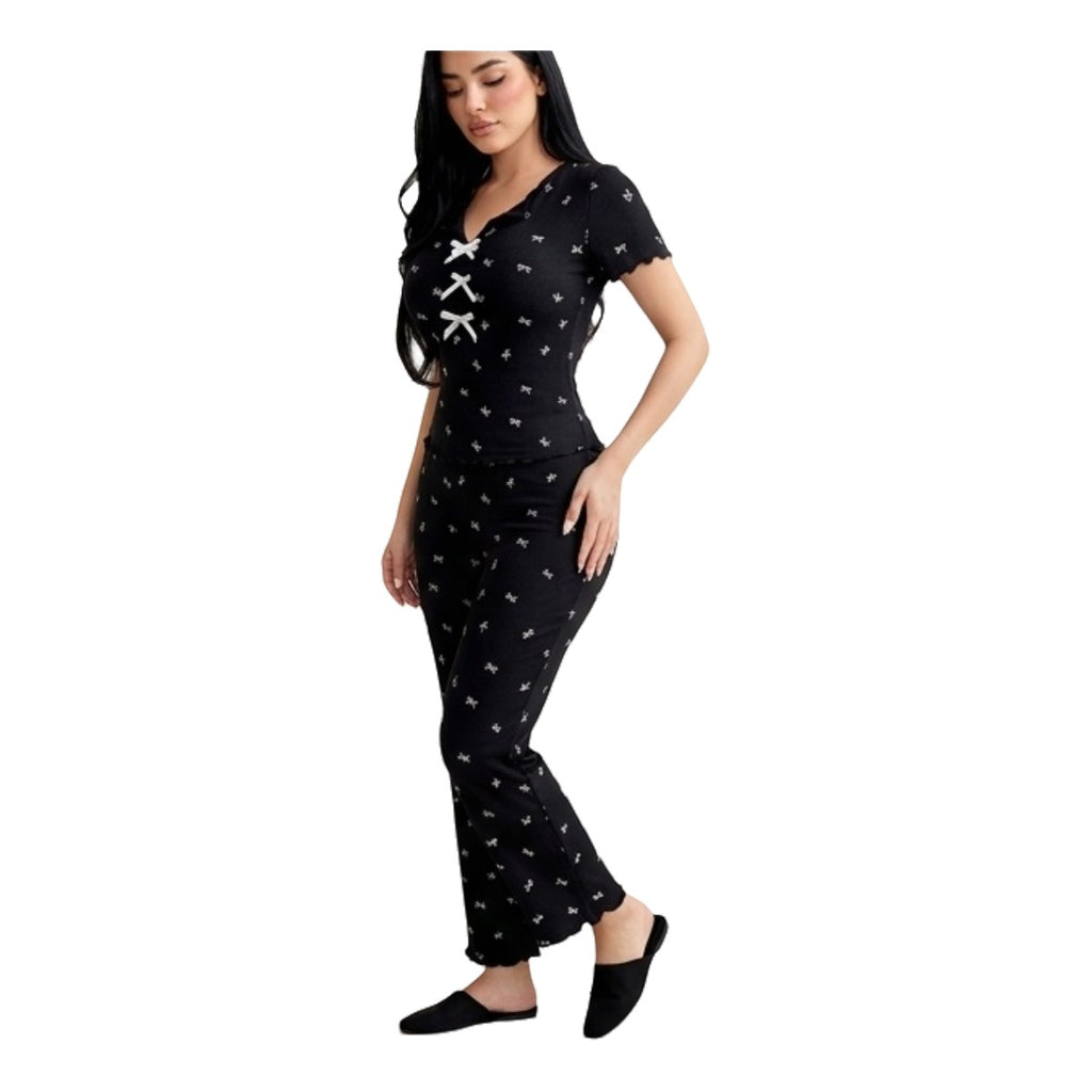 Maaak.store black cotton-lycra loungewear set with white bow print, front tie detail, and scalloped sleeve edges.